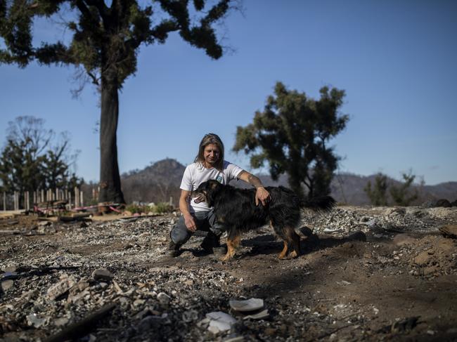 EMBARGO FOR TWAM 27 JUNE 2020 FEE APPLIESJamie Robinson at his property in Yowrie, NSW, that was destroyed by bushfire on 31 December 2019. Jamie is pictured with his dog Omi. Jamie recently had a new slab donated to him though the Fire Relief Run, that is assisting people who have been affected by bushfires. Picture by Sean Davey.