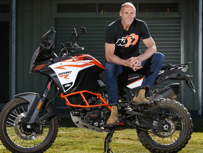 Tony in his happy place, sitting on the back of an adventure bike. Picture: Michael Klein