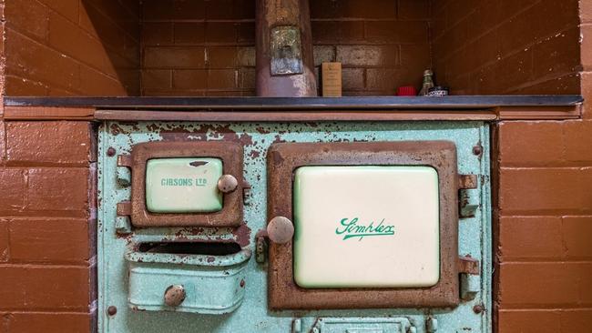 The retro home includes a kitchen fireplace with old fire cooker.