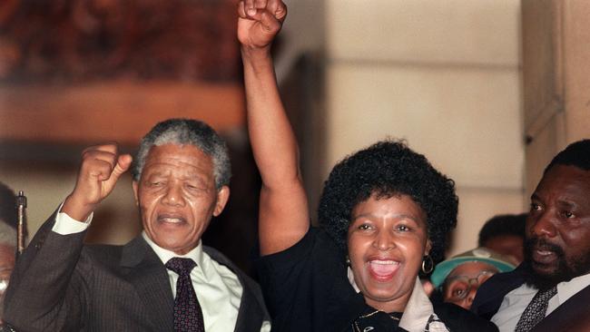 (Anti-apartheid leader and African National Congress member Nelson Mandela and his then-wife Winnie raise their fists upon Mandela's release from Victor Verster prison. AFP PHOTO / AFP FILES / WALTER DHLADHLA