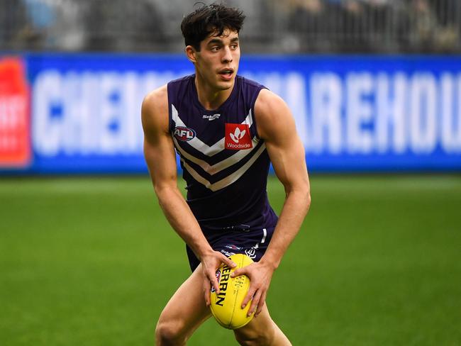 PERTH, AUSTRALIA - AUGUST 08: Adam Cerra of the Dockers looks at his options during the 2021 AFL Round 21 match between the Fremantle Dockers and the Brisbane Lions at Optus Stadium on August 8, 2021 in Perth, Australia. (Photo by Daniel Carson/AFL Photos via Getty Images)