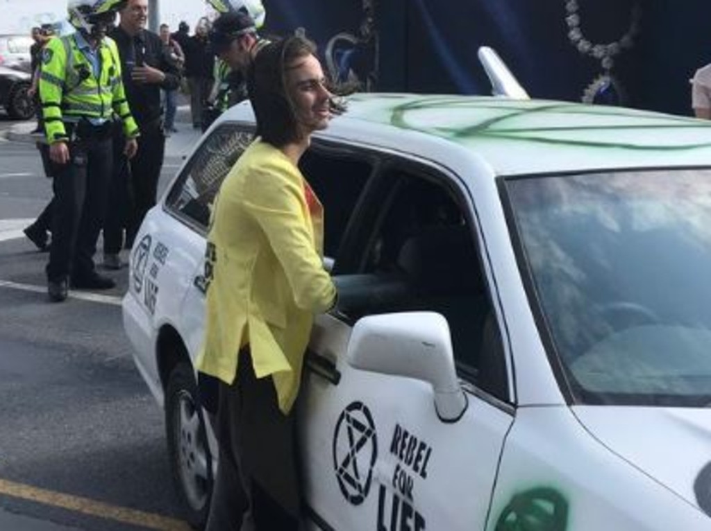 Climate protester Eric Herbert has chained himself to a car in Brisbane. Picture: Twitter: Bianca Stone