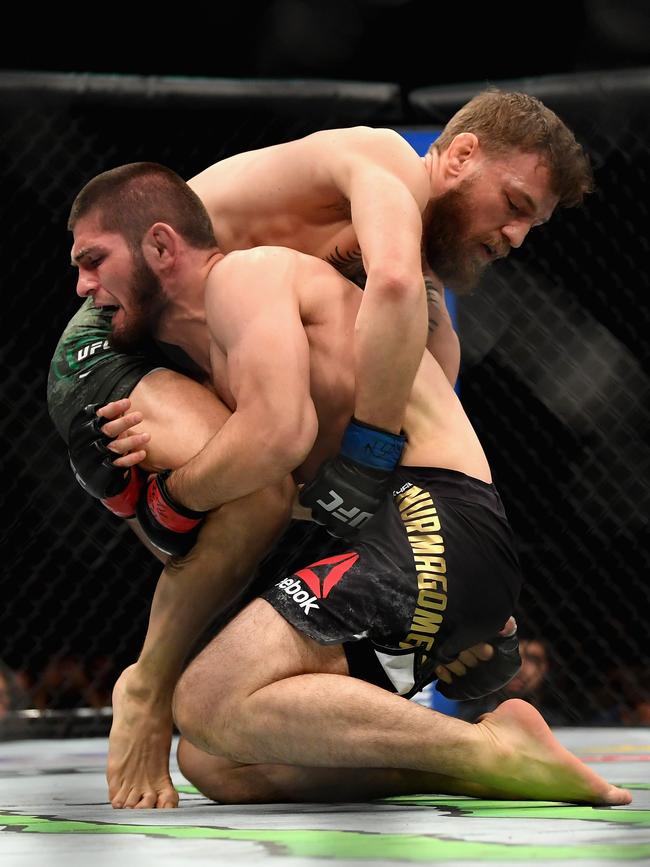 Nurmagomedov brings McGregor down.