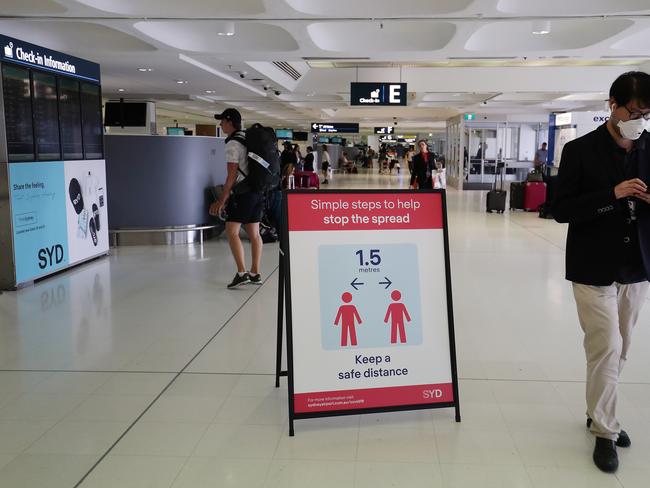 Health advice notices are seen at Sydney Airport. Picture: Getty Images