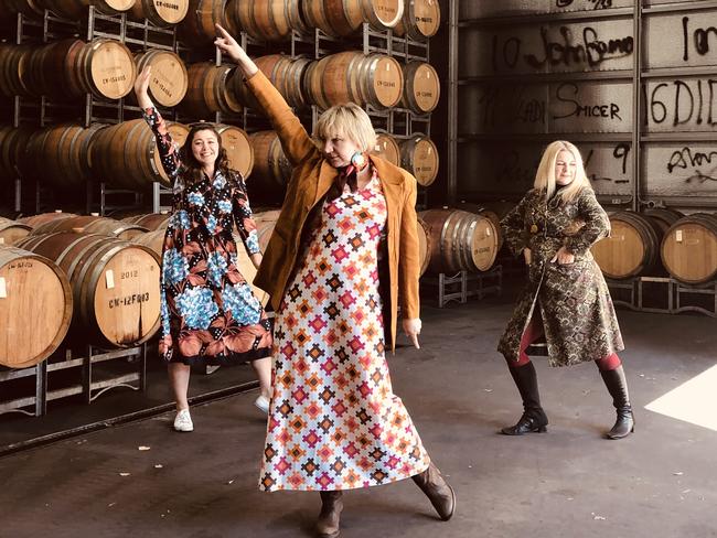 Claymore Wines general manager Carissa Major, centre, at a 'Friday's frock up party' in the barrel hall with work colleagues.