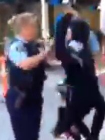 The girl lashes out at the officer. Picture: 9 News