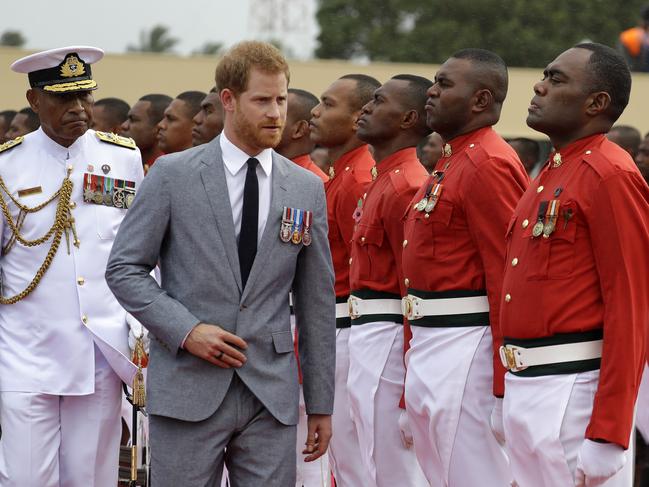 Prince Harry inspects a guard of honour after arriving in Fiji. Picture: AP/Kirsty Wigglesworth