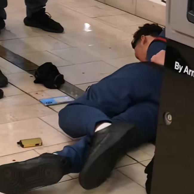 Footage circulating on social media shows a man pinned to the ground.