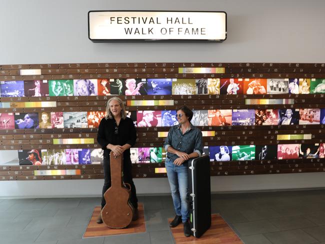 Powderfinger guitarists Darren Middleton (right) and Ian Haug perform below Brisbane's CBD and the former Festival Hall. Picture: Cross River Rail