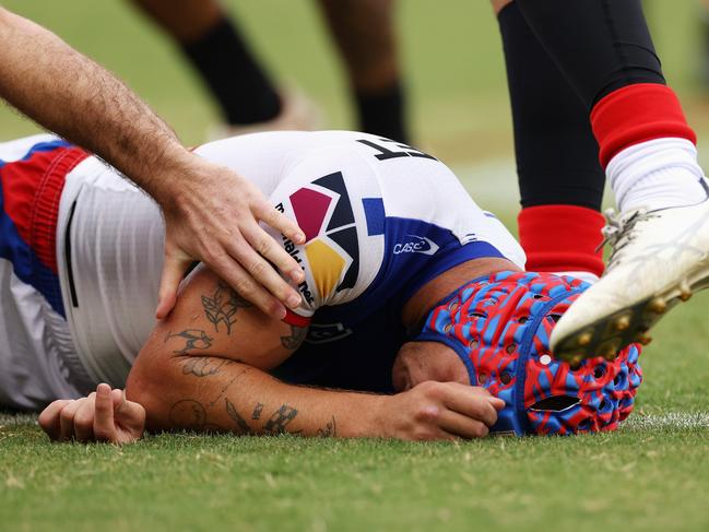 SYDNEY, AUSTRALIA - MARCH 12: Kalyn Ponga of the Knights lays on the ground after colliding with Asu Kepaoa of the Tigers during the round two NRL match between Wests Tigers and Newcastle Knights at Leichhardt Oval on March 12, 2023 in Sydney, Australia. (Photo by Cameron Spencer/Getty Images)