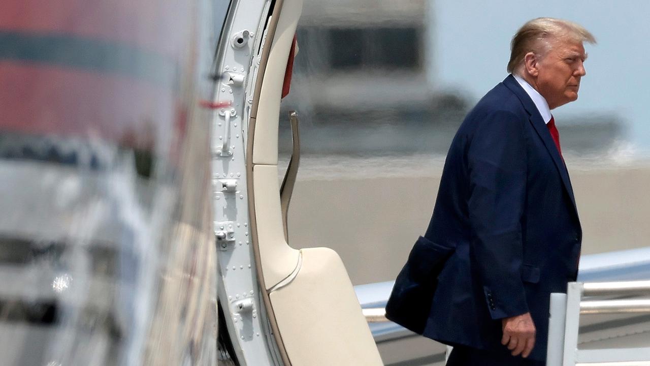 Mr Trump disembarking from his private plane as he arrived in Florida yesterday. Picture: Win McNamee/Getty Images