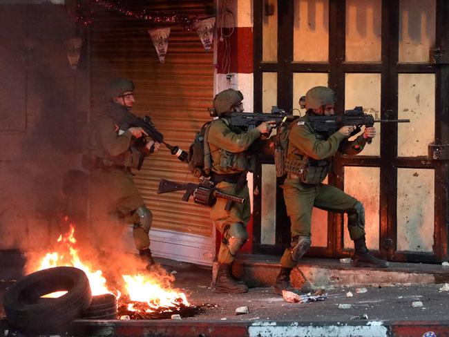 Israeli soldiers take aim during clashes with Palestinian protesters. Picture: Hazem Bader / AFP