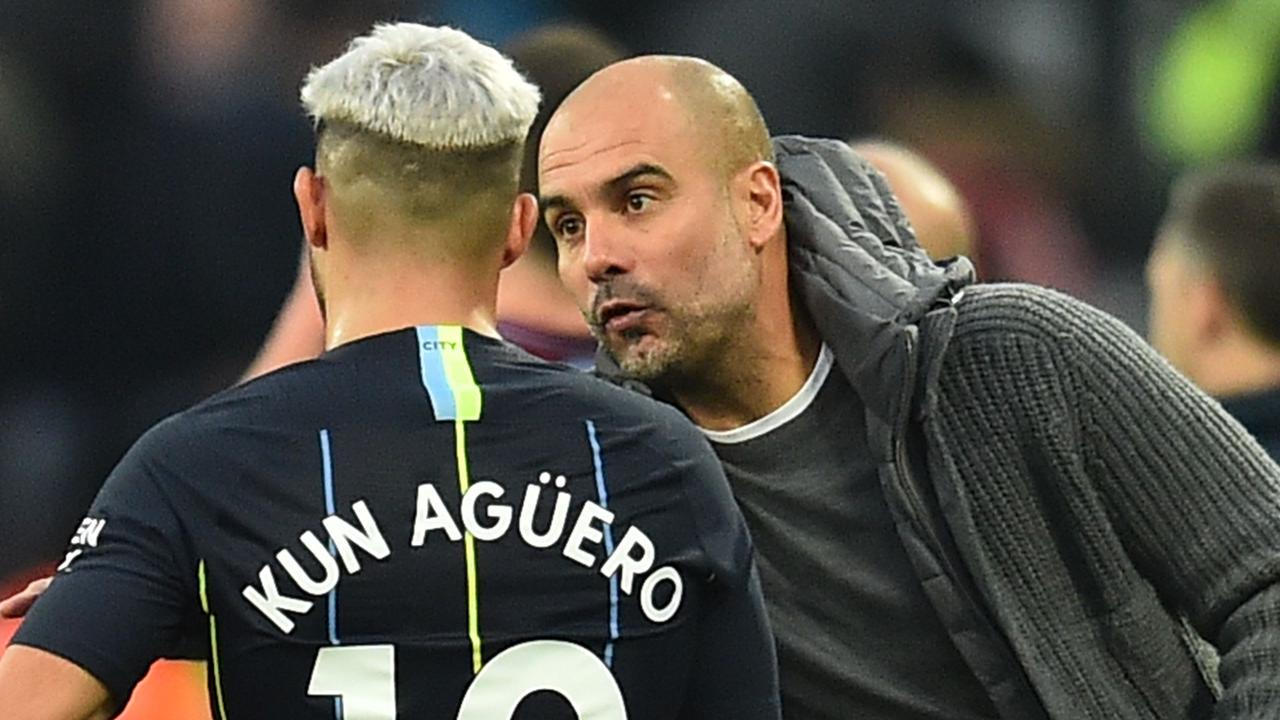 Manchester City's Spanish manager Pep Guardiola (R) speaks with Manchester City's Argentinian striker Sergio Aguero (L)