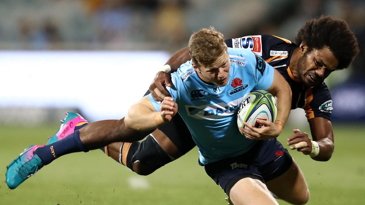 Cameron Clark of the Waratahs Is tackled by Henry Speight of the Brumbies.