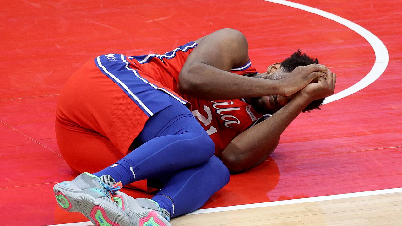 Joel Embiid reacts after getting injured. (Photo by Rob Carr/Getty Images)