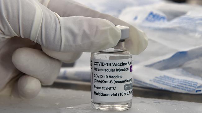 A health worker with a vial of the Oxford AstraZeneca COVID-19 coronavirus vaccine. Picture: Ryad Kramdi/AFP