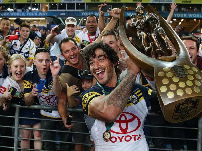 Cowboy's Johnathan Thurston holds the trophy in front of Cowboys fans after the 2015 NRL Grand Final between the Brisbane Broncos and North Queensland Cowboys at ANZ Stadium, Sydney. Pic Brett Costello