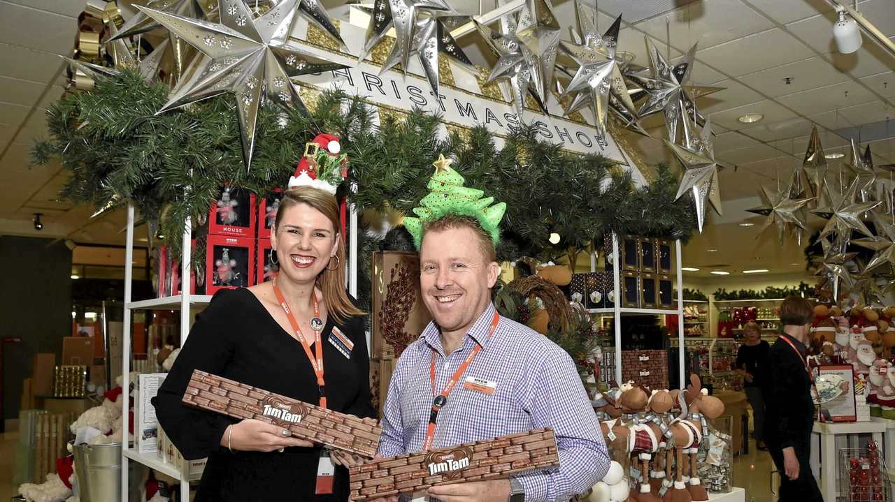 GIFTS FOR ALL: Myer&#39;s Sophie Robertson and Matt Karl get into the Christmas spirit and show off the personalised Tim Tam boxes. Picture: Bev Lacey