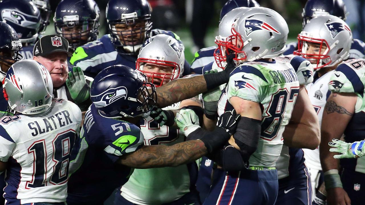GLENDALE, AZ - FEBRUARY 01: Bruce Irvin #51 of the Seattle Seahawks and Rob Gronkowski #87 of the New England Patriots exchange words after a play late in the game during Super Bowl XLIX at University of Phoenix Stadium on February 1, 2015 in Glendale, Arizona. Andy Lyons/Getty Images/AFP == FOR NEWSPAPERS, INTERNET, TELCOS & TELEVISION USE ONLY ==