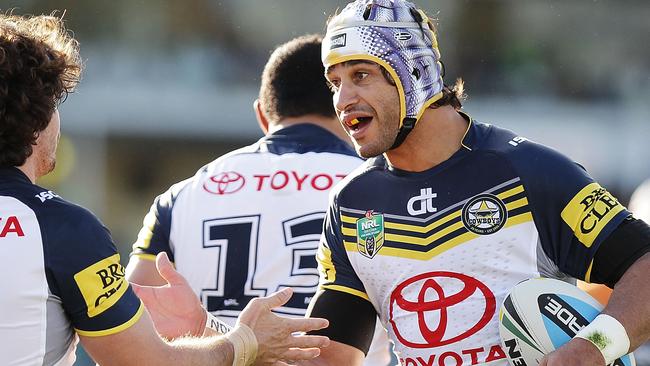 Johnathan Thurston congratulates Jake Granville of the Cowboys after scoring a try.