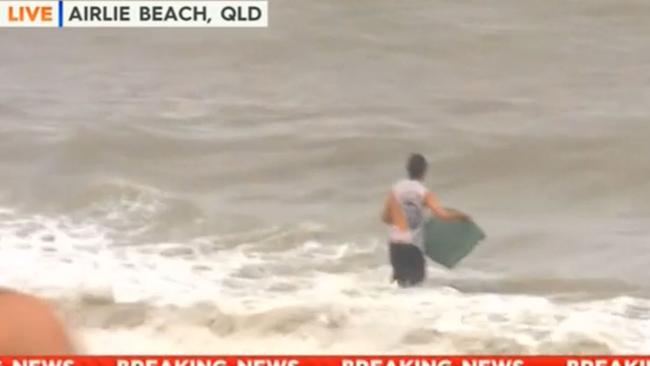 The man takes the plunge ahead of ducking under a wave. Picture: Channel 9