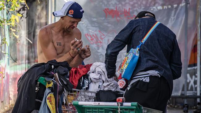 A man openly uses drugs at a common thoroughfare between Acland St and Woolworths in St Kilda. Picture: Jason Edwards