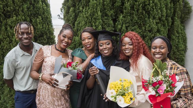 Bachelor of Nursing graduate Dominika Wilberforce celebrates with family and friends (from left) Charles Eremugo, Mary Mogga, Suzan Poni, Irene Nasande and Lasto Bilal at a UniSQ graduation ceremony at Empire Theatres, Tuesday, February 13, 2024. Picture: Kevin Farmer