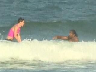 Sia Soliola being rescued from the surf.