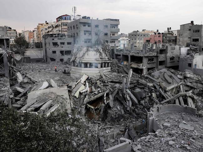 TOPSHOT - Palestinians inspect the destruction around Ahmed Yassin mosque, which was levelled by Israeli airstrikes, in Gaza City early on October 9, 2023. Israel relentlessly pounded the Gaza Strip early October 9, as fighting raged with Hamas around the Gaza Strip and the death toll from the war against the Palestinian militants surged above 1,1000. (Photo by MOHAMMED ABED / AFP)