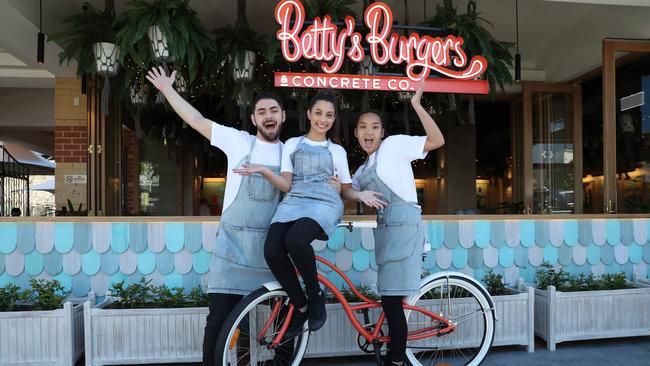 Ryland Joyce, Annalise Sergi and Ysabella Nieves pose for a photo at Betty's Burgers today, August 4, 2018. Betty's Burgers and Concrete Co. held its grand opening in Castle Towers Piazza today. (AAP Image/David Swift)