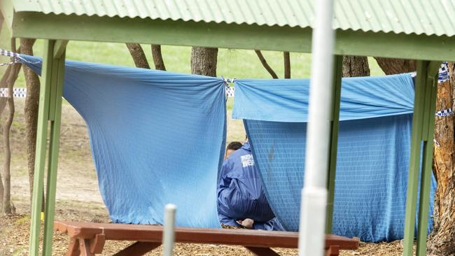 Police erect a tarpaulin where the body was found. Picture: Jenny Evans