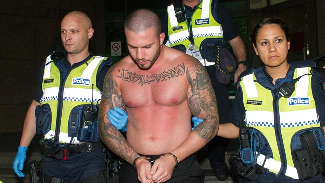 Abdulrahim being taken away by police at the Melbourne Magistrates’ Court in February. Picture: STUART WALMSLEY