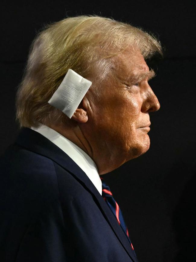 Trump wearing a bandage over his ear. (Photo by Patrick T. Fallon / AFP)