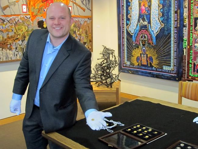 Channelled his inner Indiana Jones to find the coins ... Philip Kiernan, a University at Buffalo assistant professor and expert on ancient coins, displays one of 12 gold Roman coins. Picture: AP / Carolyn Thompson