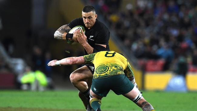 Sonny Bill Williams of the All Blacks is tackled by Sean McMahon.