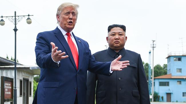 Donald Trump and Kim Jong-un at the border between North and South Korea yesterday during their historic meeting. Picture: AFP