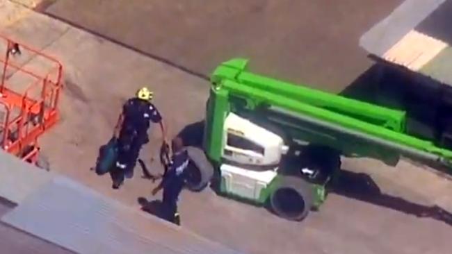 Firefighters were trying to reach a man they believe was electrocuted on the roof of a work site in south west Sydney today. Picture: Seven News