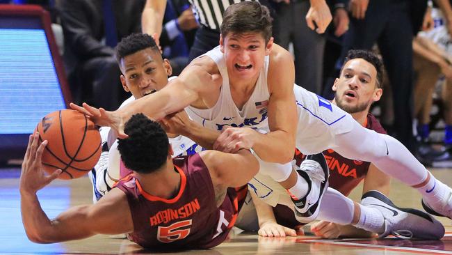 Grayson Allen of Duke (top) dives on Justin Robinson of Virginia Tech.