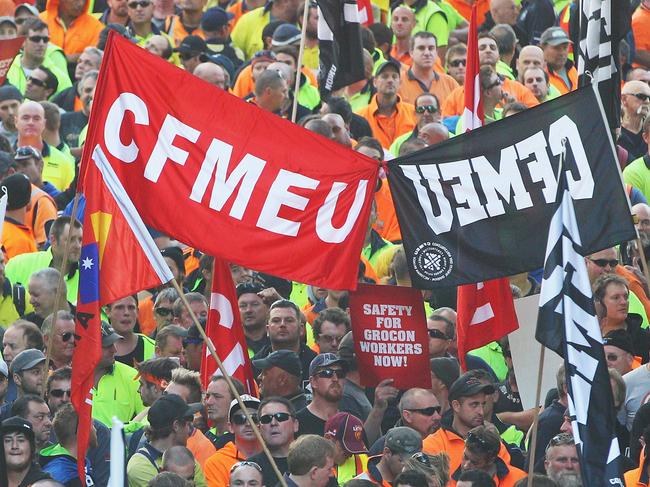 MELBOURNE, AUSTRALIA - APRIL 30: Construction workers march past the Myer Emporium site during the Grocon Rally and March on April 30, 2013 in Melbourne, Australia. The Construction, Forestry, Mining and Energy Union (CFMEU) organised the protest calling for building giant Grocon to improve its safety standards. (Photo by Scott Barbour/Getty Images)