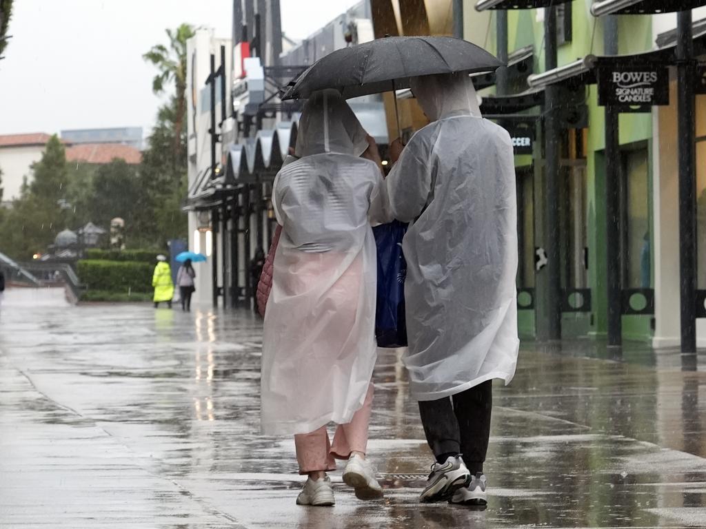 Tourists take in a last minute visit to Disney Springs entertainment complex. Picture: John Raoux/AP