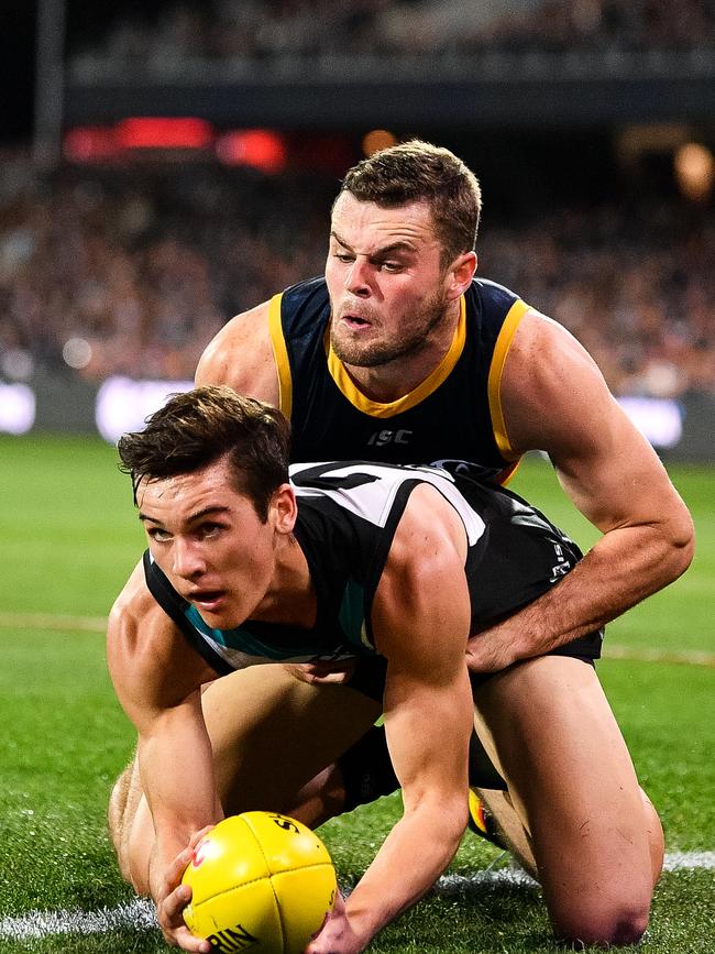 Port Adelaide’s Connor Rozee is tackled by Adelaide’s Brad Crouch in Showdown 46 at Adelaide Oval. Picture: Daniel Kalisz/Getty