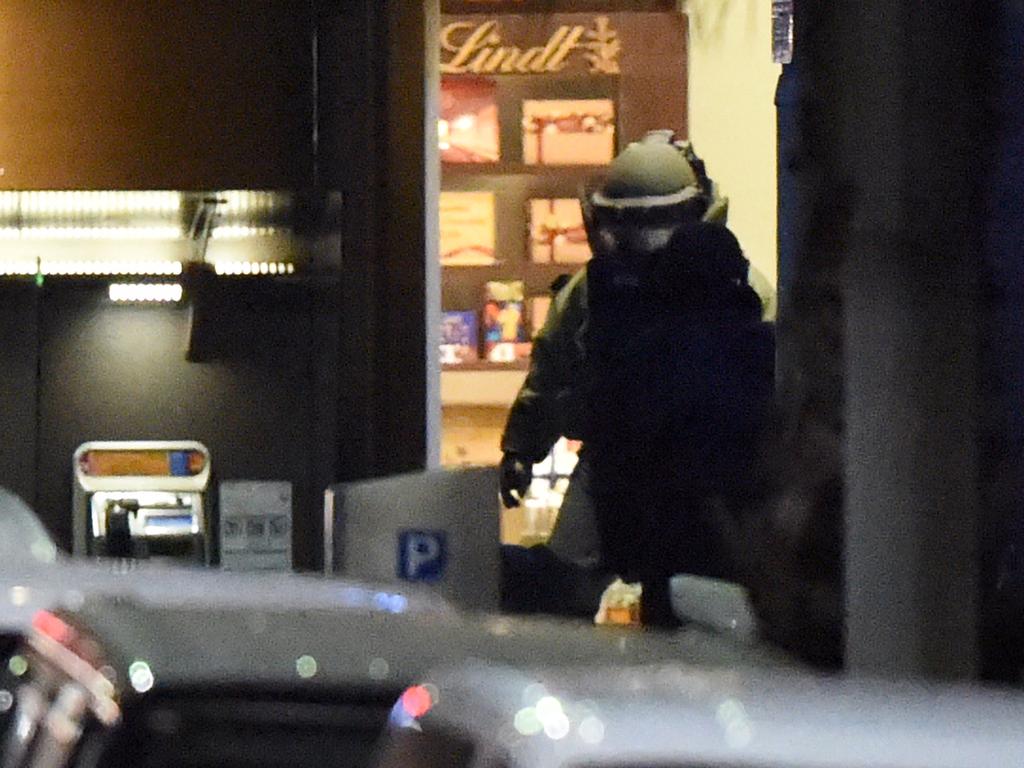 A bomb disposal expert leaves the cafe. Picture: William West (AFP)