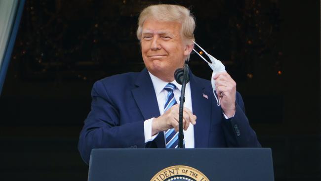 US President Donald Trump takes his mask off before speaking from the South Portico of the White House at the weekend. Picture: AFP