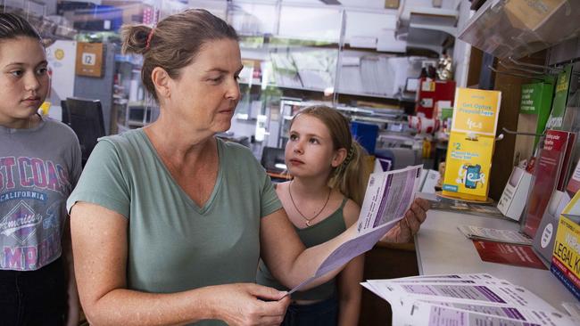 Freshwater resident Kelly Hopgood picks up election material at the Stratford post office watched by her daughter Isabella Cater and friend Lily Santos. Picture: Brian Cassey