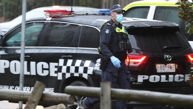 Police keep watch on the towers on Racecourse Road in Flemington. Picture: David Crosling