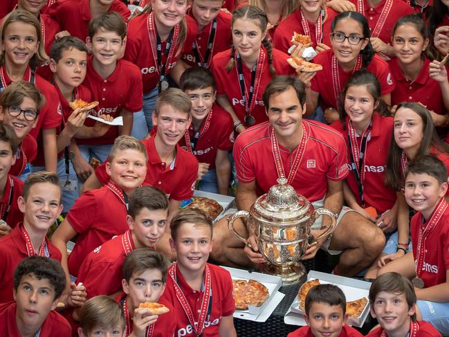 Former Basel ball boy Roger Federer throws a pizza party for the ball kids after defeating Australia's Alex de Minaur during the final match at the Swiss Indoors ATP500 tennis tournament. Picture: Fabrice Coffrini/AFP