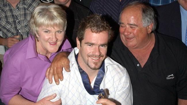 Footballer Mark Ricciuto wearing the Brownlow Medal with his parents Carolyn and Murray at the Alma Tavern in Norwood in 2003.