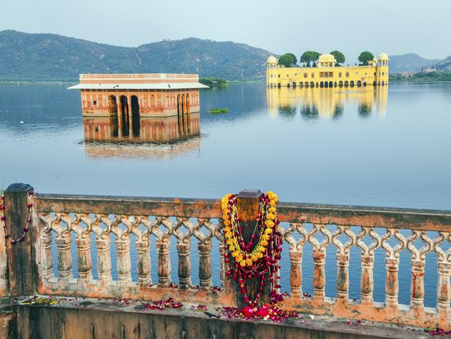 A view of the Jal Mahal and a fortress from the nearby land.