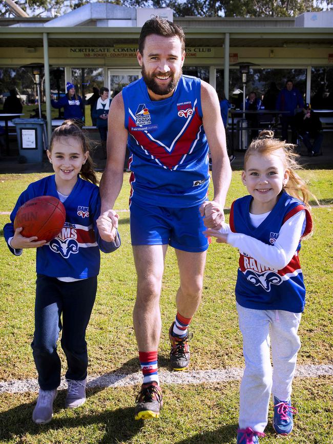 Harding runs out for game 450 at Duncan Fraser Reserve with daughters Mia and Ella by his side. Picture: AAP/Mark Brake