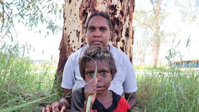 Jaydene Turner, 25, with son Devvon Webb, 8, at Amoonguna. Many in their community about 15km outside Alice Springs has welcomed the recent return of alcohol bans. Picture: Riley Walter